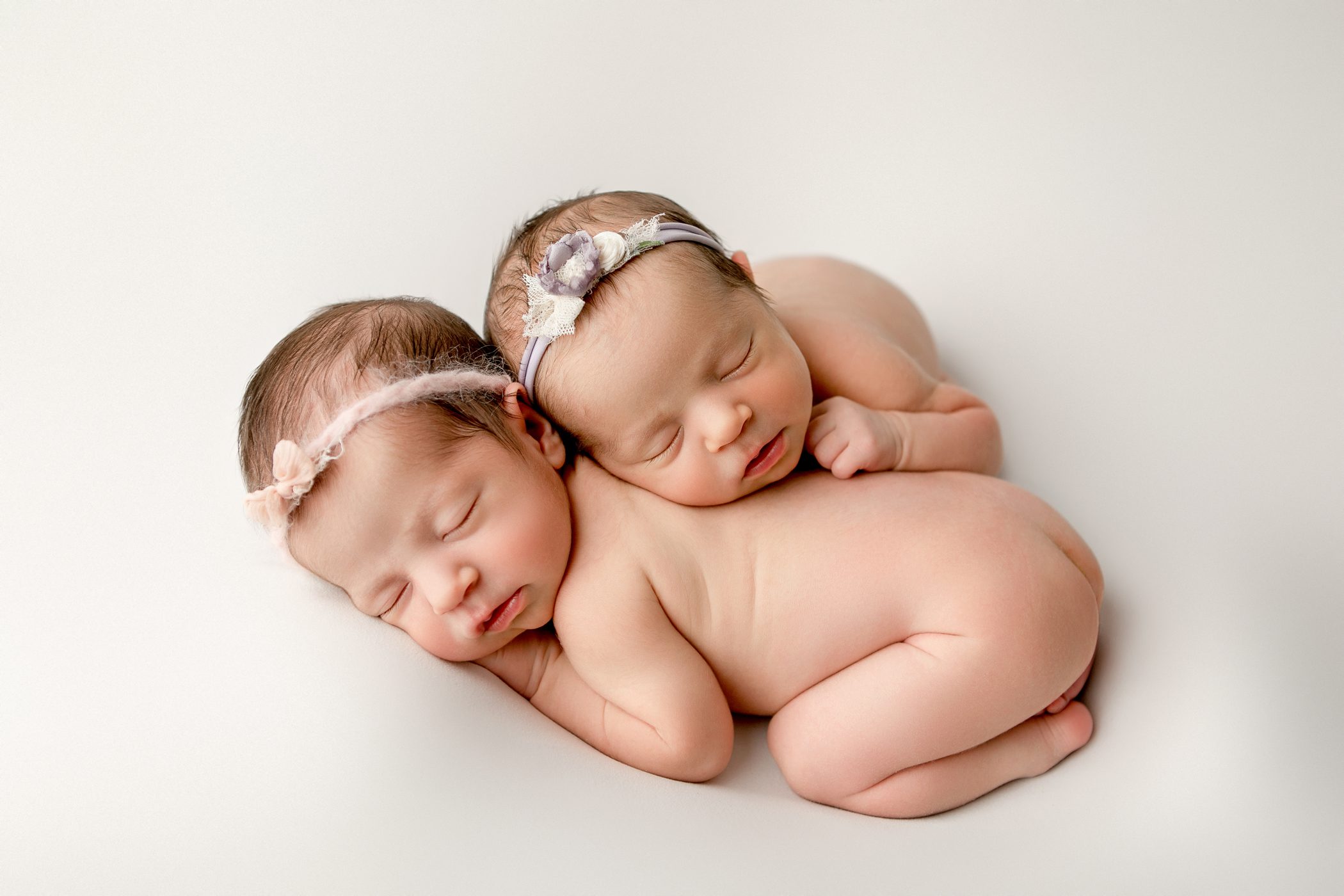 newborn twin girls sisters snuggled together fresno clovis photography studio