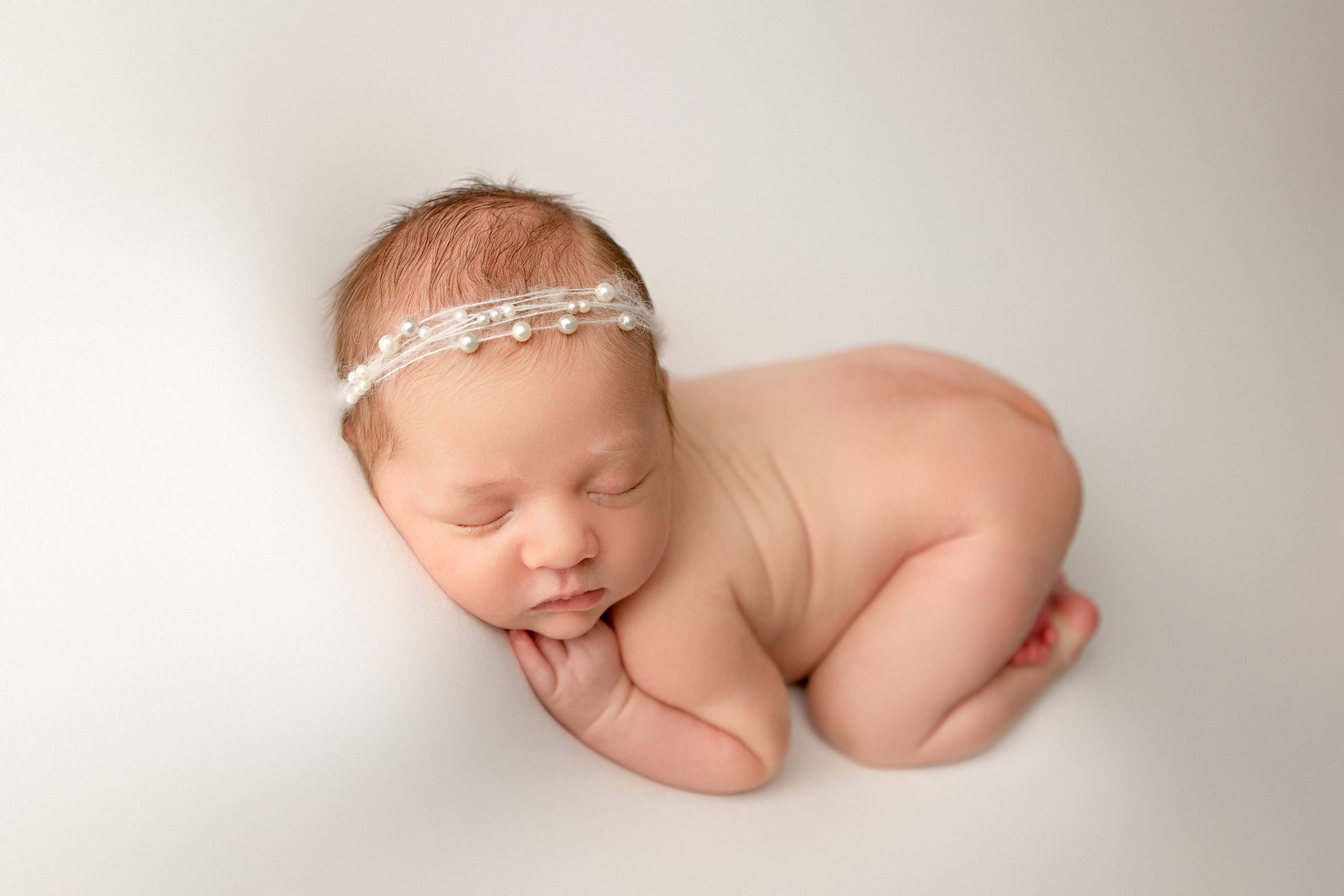 fresno newborn baby girl tushy up bum up pose white background pearl headband fresno clovis california