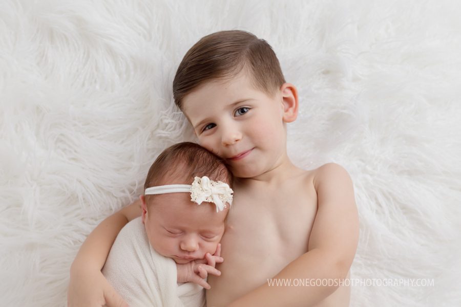 Newborn girl in arms of big brother, siblings, fresno photographer