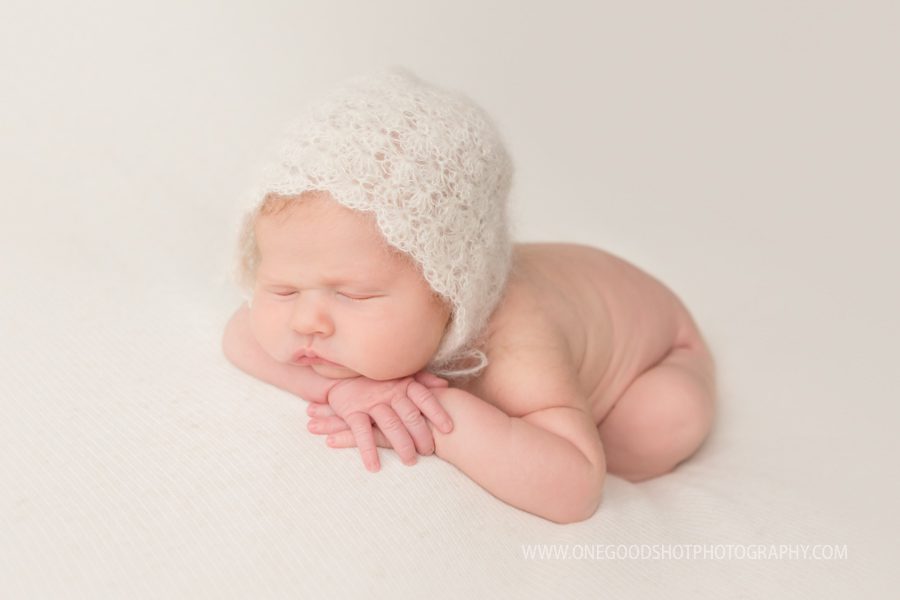 newborn girl, head on hands, vintage bonnet, cream, white 