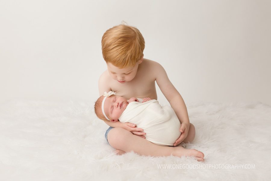 red heads, siblings, big brother holding baby sister