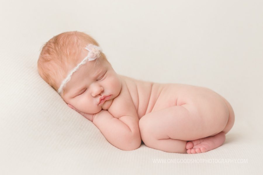 newborn girl, red head, ginger, bum up, bushy up pose, pink and white