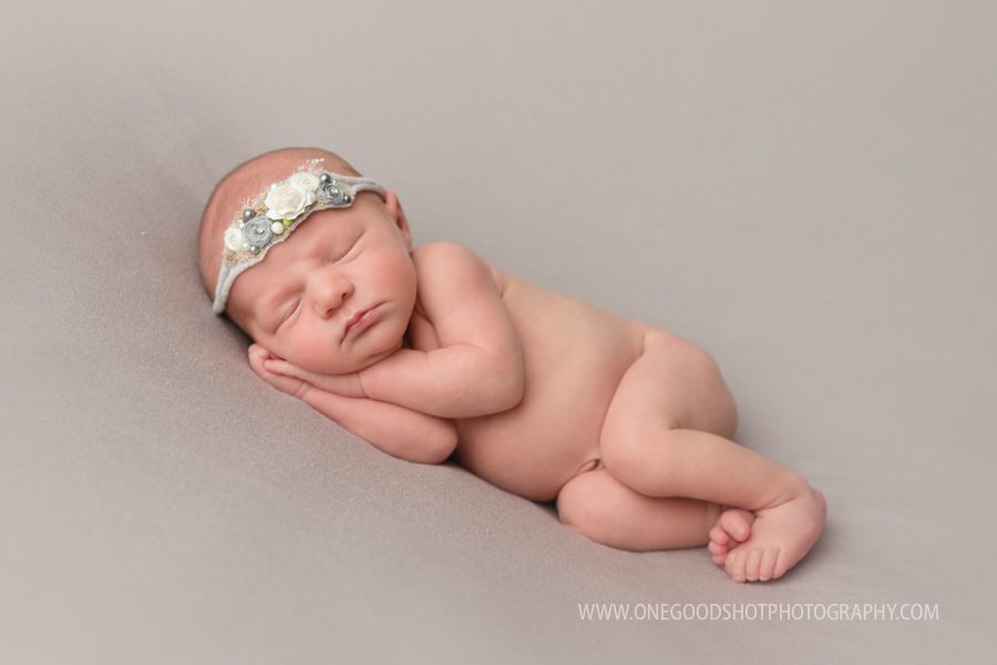 newborn girl, side lying pose, head on hands