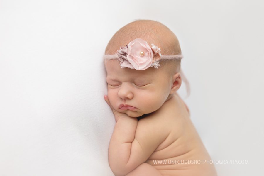 newborn baby girl, side lying pose, pink and white, floral tieback, fresno photographer