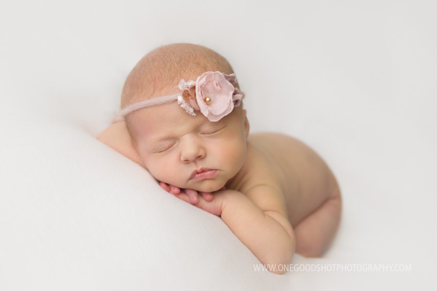 newborn baby girl, fresno, ca, head on hands, flower tieback