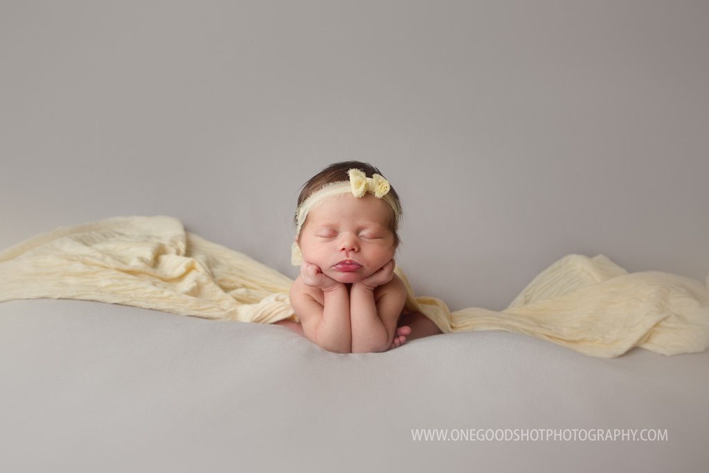 newborn girl, froggy pose, gray and yellow