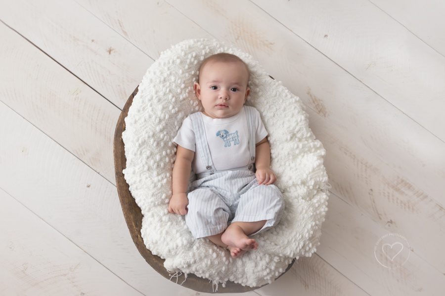 3 month old baby boy wearing light blue and white jumper in bowl