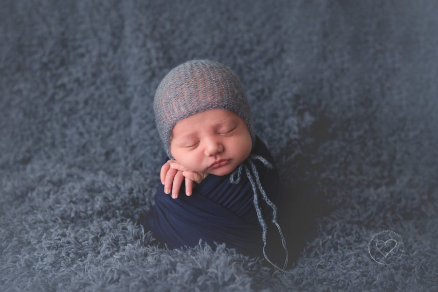 newborn boy, navy, potato sack pose, blue bonnet, a boy in blue