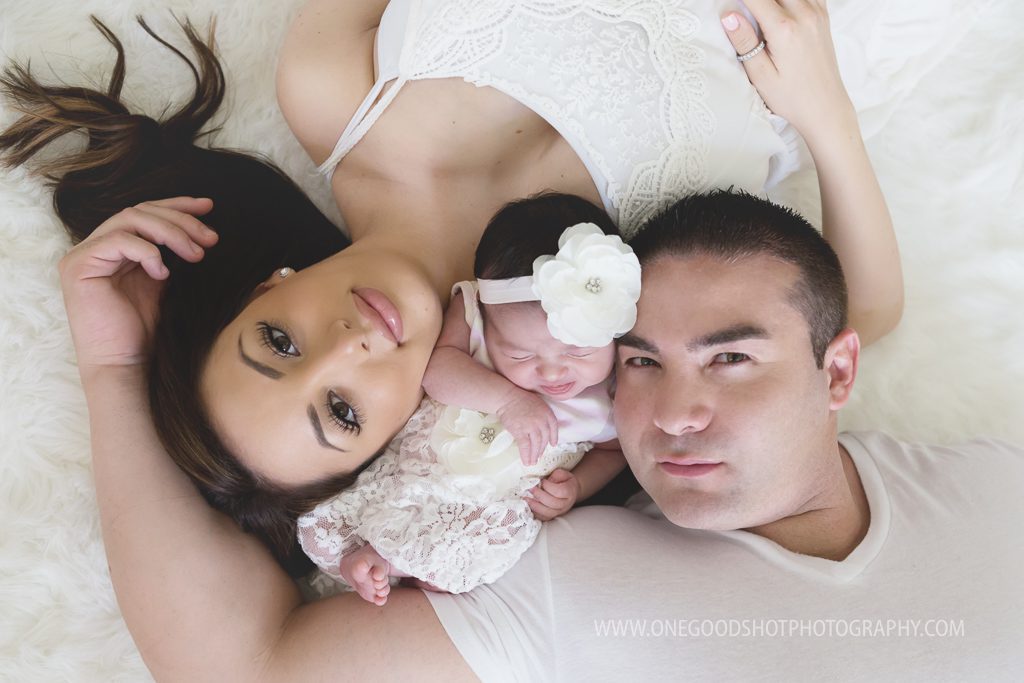 new parents, mommy, daddy, newborn girl, laying on floor