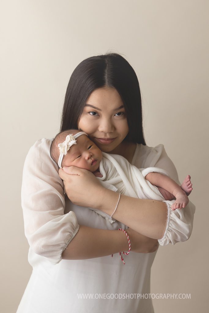 newborn girl in mom's arms fresno photographer