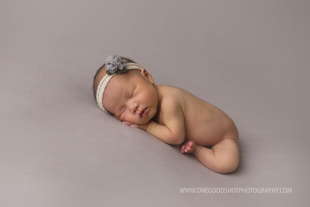 newborn girl in a taco pose on a gray backdrop, fresno photographer
