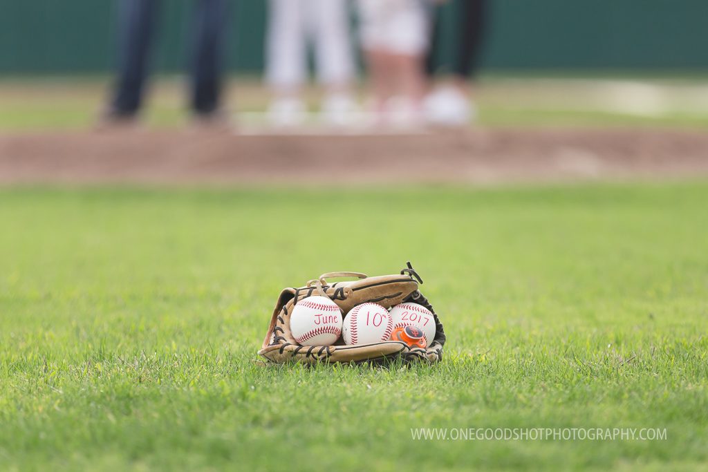 baseball pregnancy announcement, baseballs in glove on baseball field