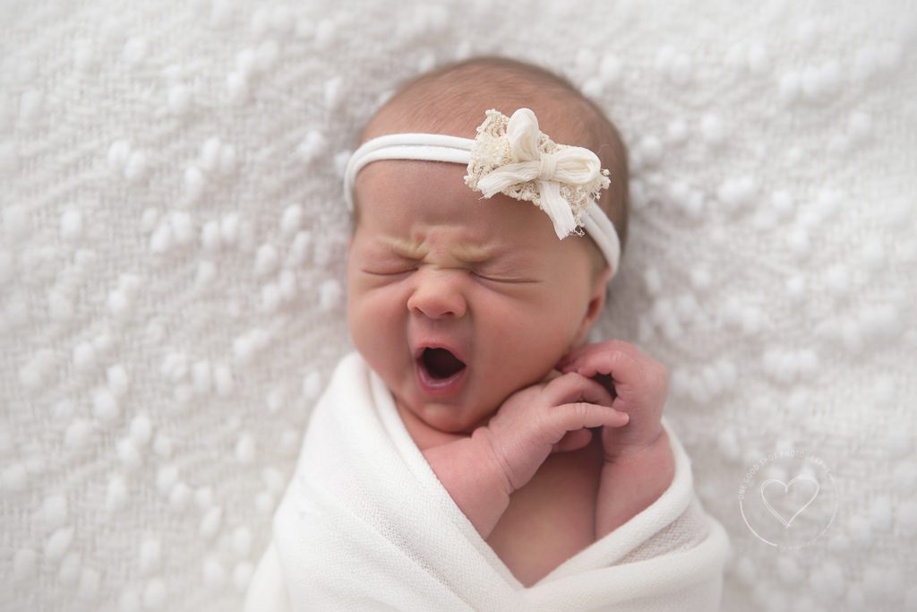 newborn girl yawning