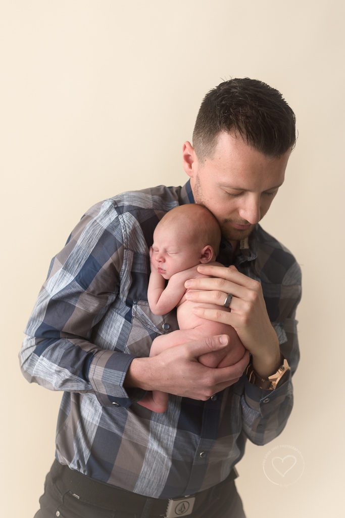 dad snuggling newborn boy, fresno newborn photographer