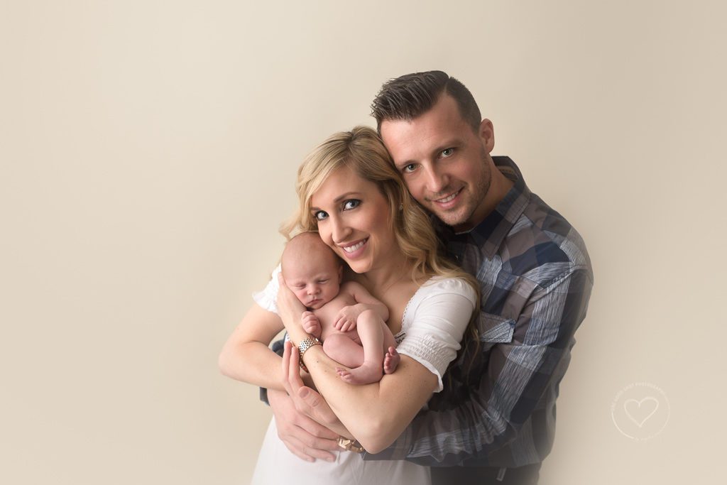 newborn boy in mom and dads arms, fresno newborn photographer