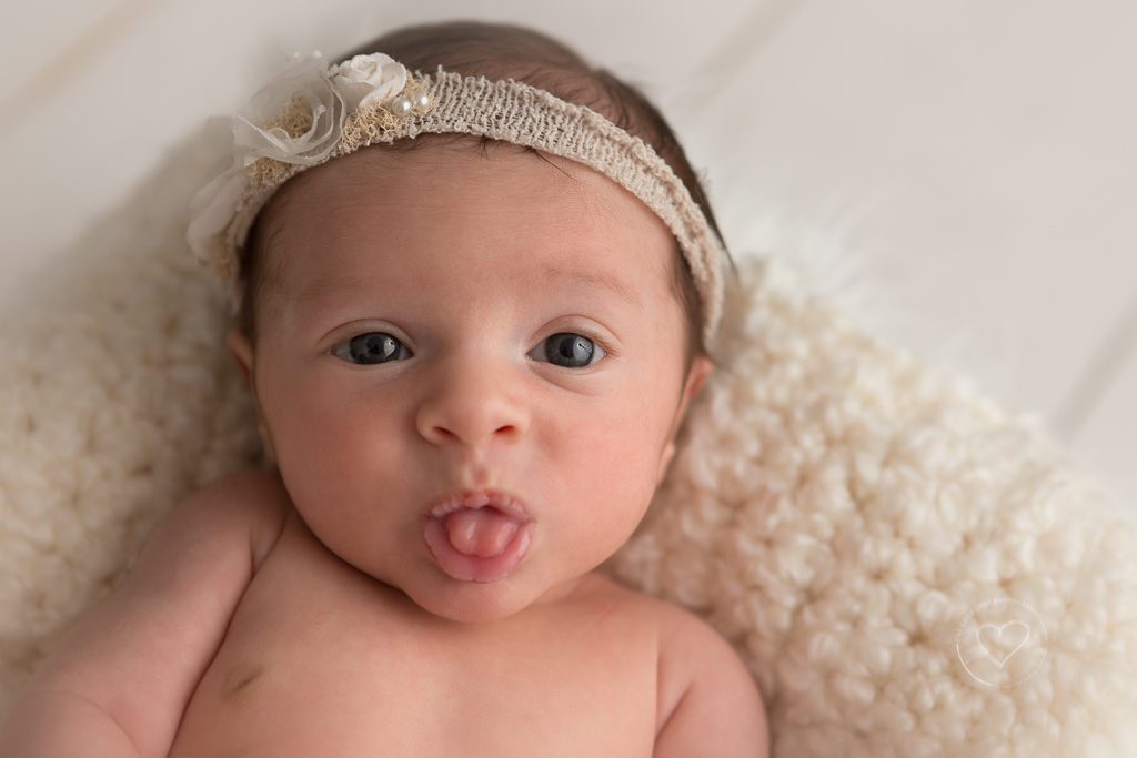 One Good Shot Photography | Fresno Newborn Photography, newborn girl, baby awake, creams, neutrals, natural baby, baby sticking out tongue