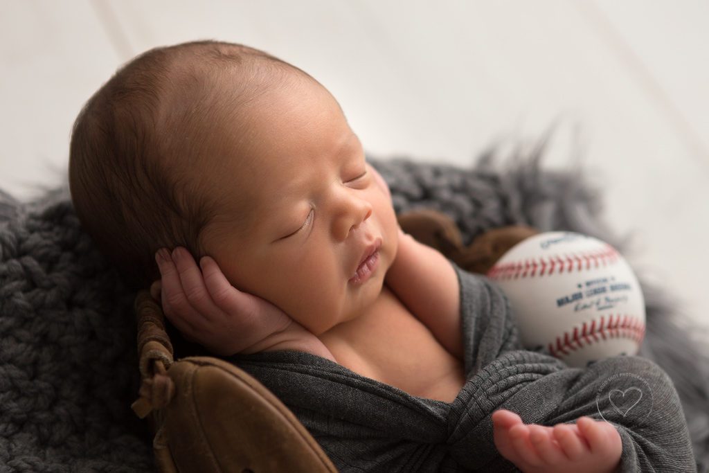 Newborn boy, hands on face, baseball glove, Fresno newborn photographer