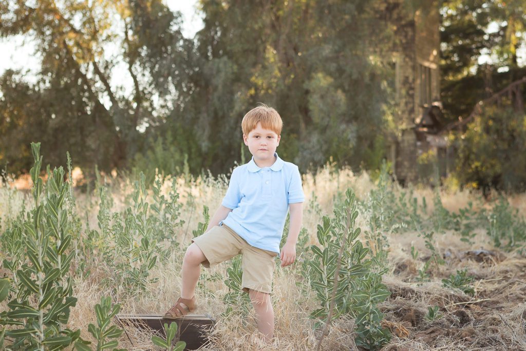Fresno child photographer, Boy on box in a field