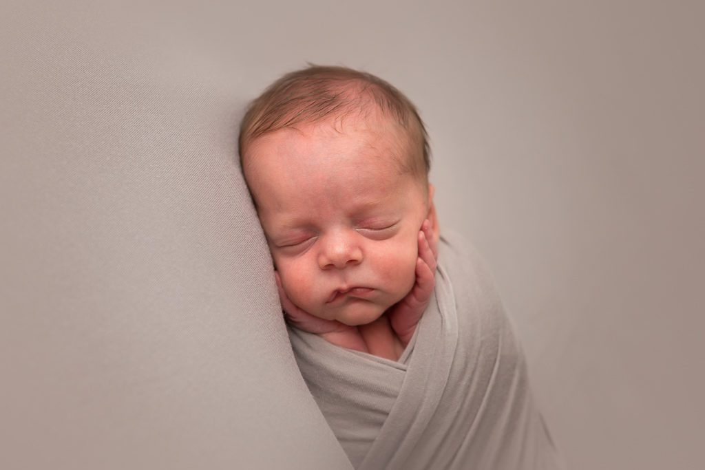 Fresno Newborn Photographer, One Good Shot Photography, Newborn Boy, Face in Hands, Gray