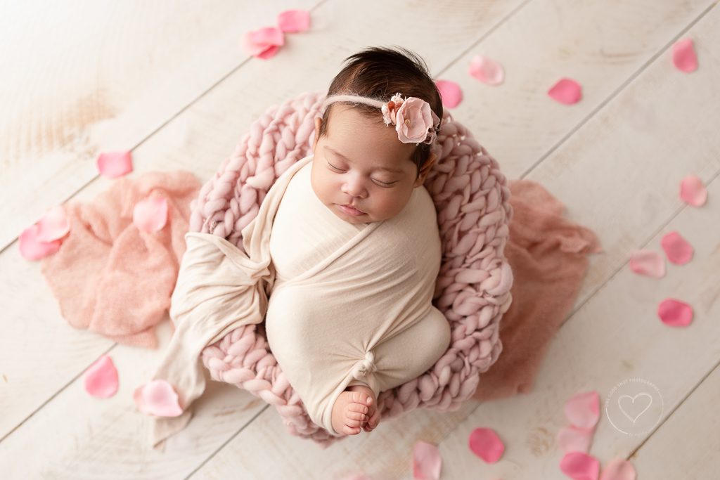 newborn girl, wrapped, pink, flower petals, fresno newborn photographer