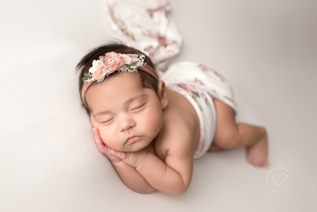 newborn girl, floral wrap, white background, fresno photographer, side lying