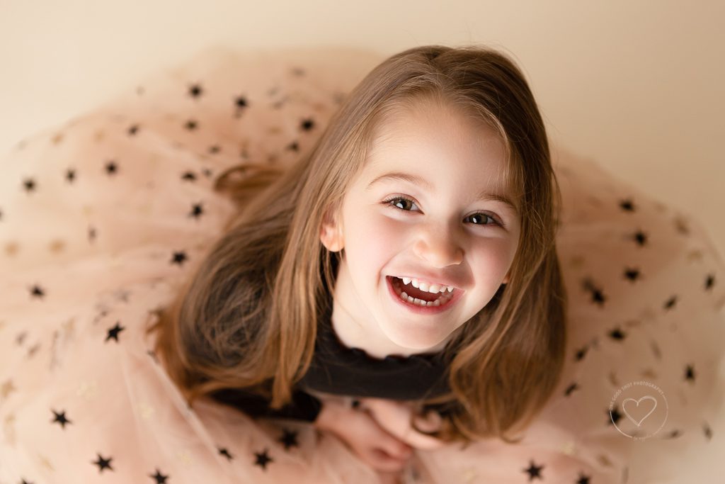 Little girl, 3 year old, Milestone Session, looking up , smiling, happy