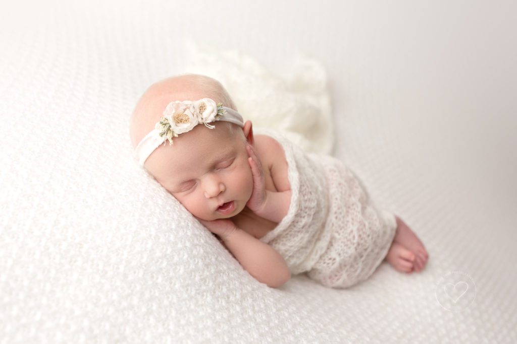 Newborn baby photographer, fresno, clovis, newborn girl, side lying, hands on cheeks, all white