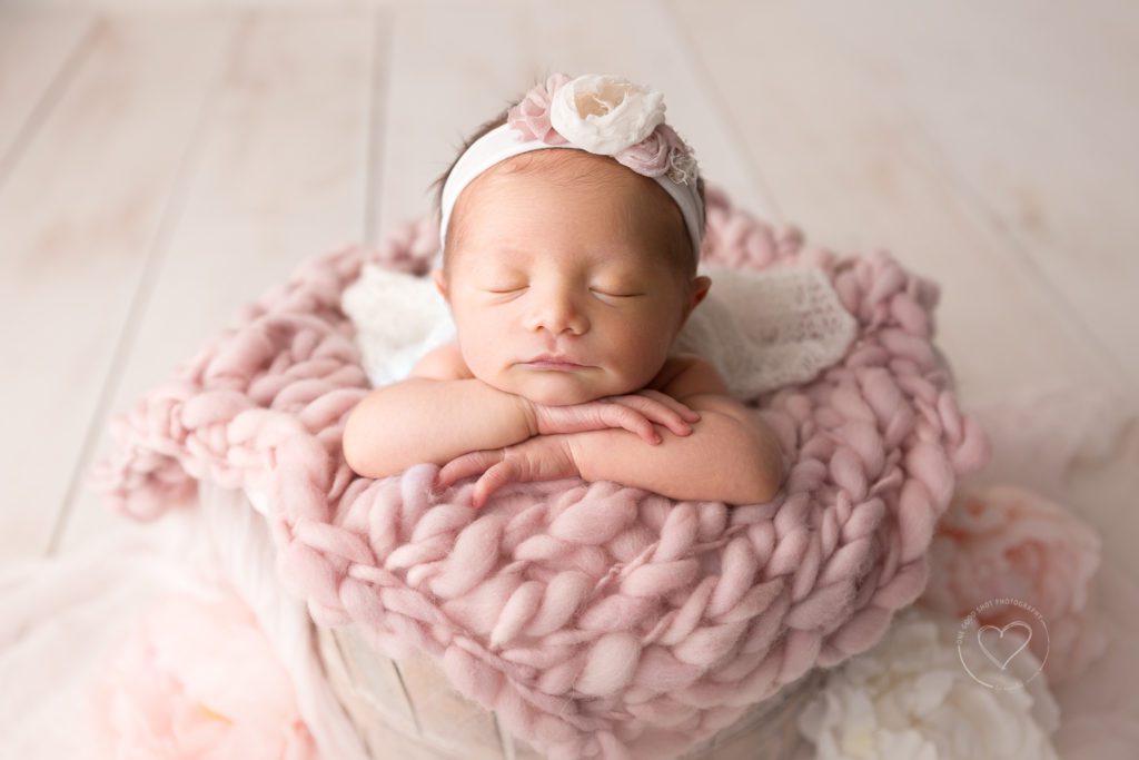 Fresno newborn photographer, head on hands, bucket pose, pink and white layers