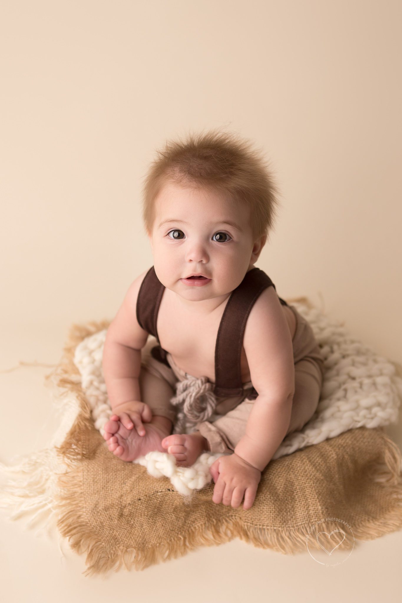 baby boy, 6 months old, sitter, wearing brown coveralls, sitting in bowl, neutral layers. Fresno baby photographer
