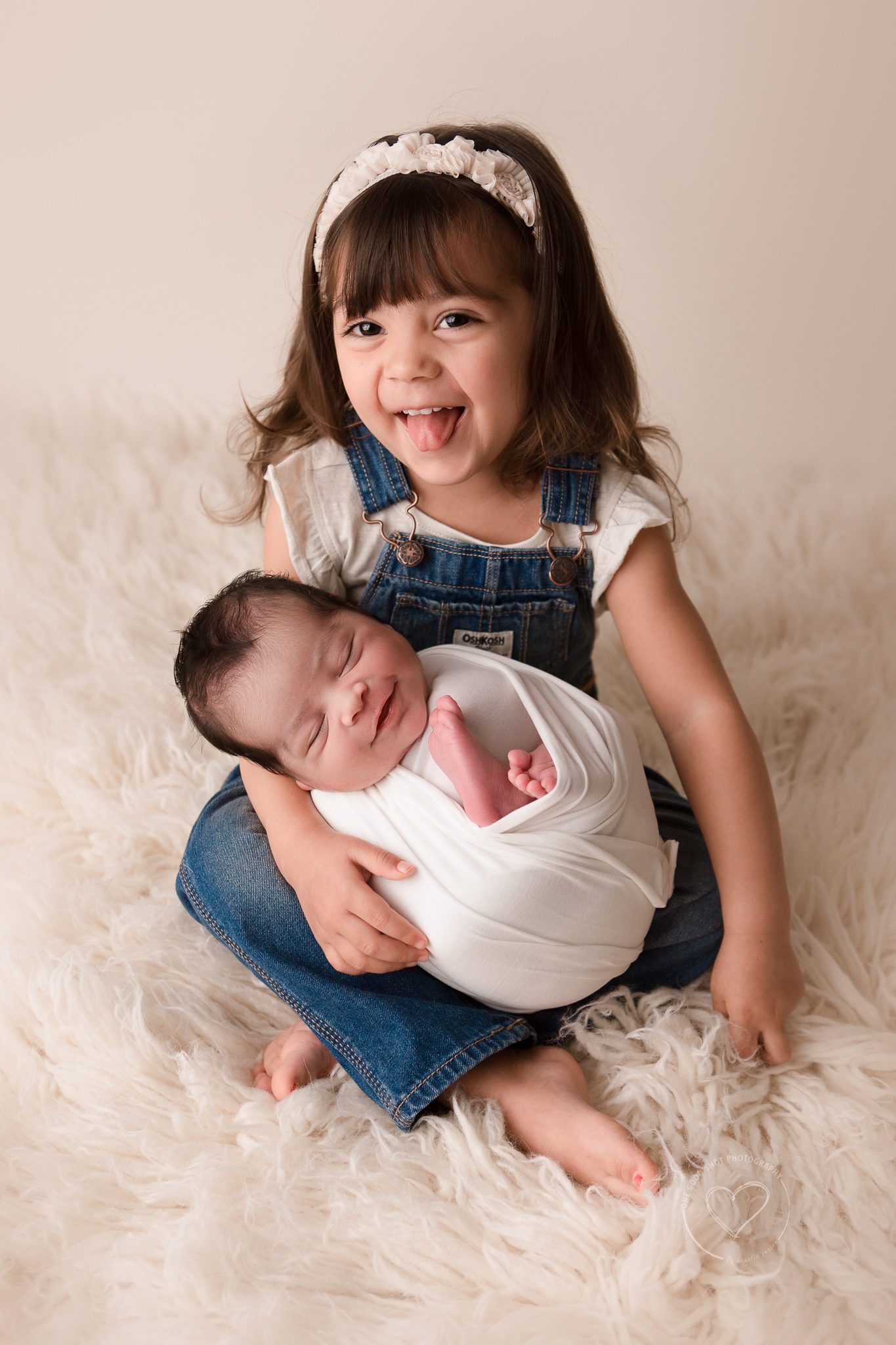 big sister holding newborn brother, smiling, Fresno, photographer