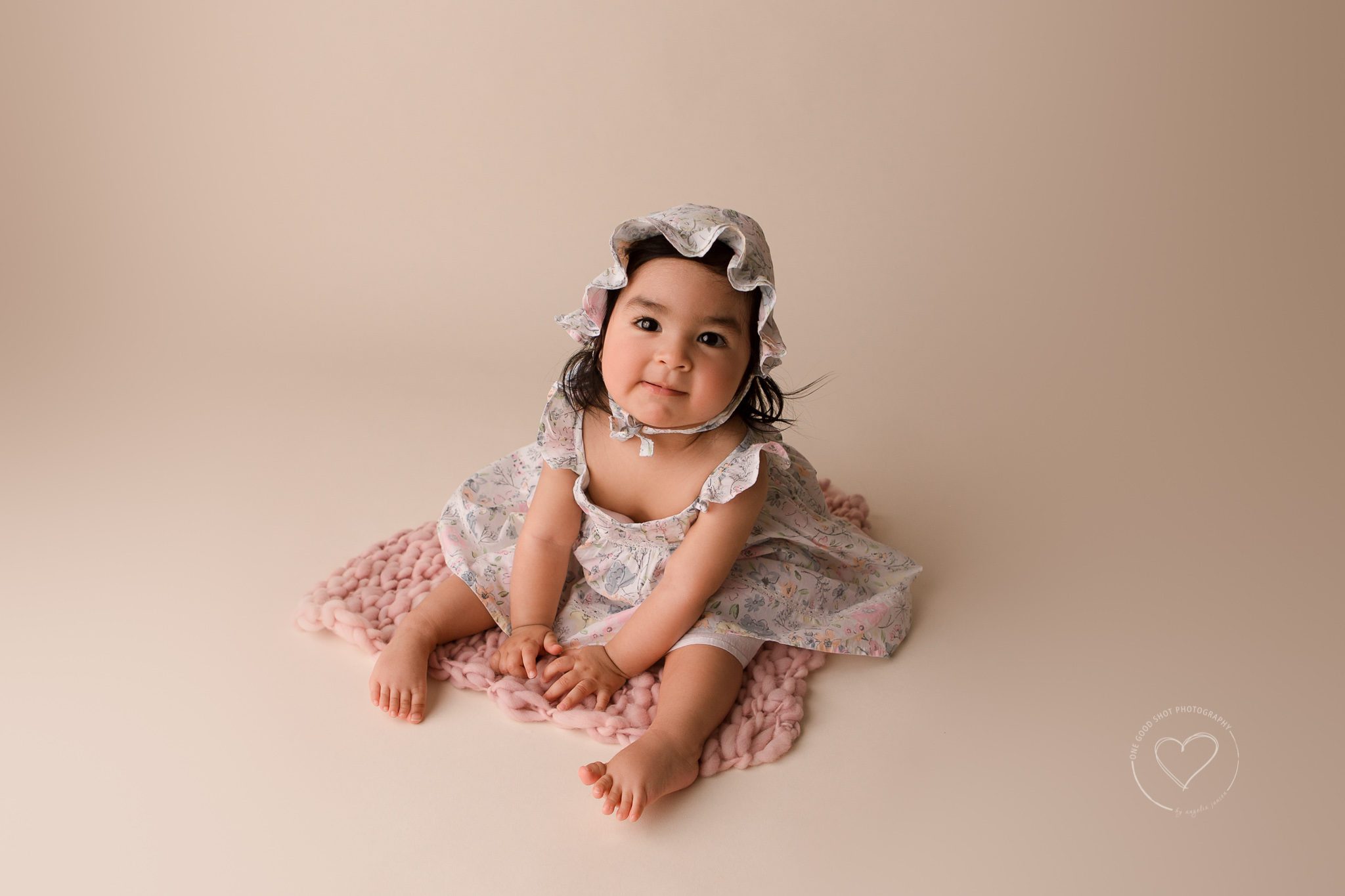 9 month old baby girl, sitting, milestone session, fresno, clovis, wearing spring floral dress and bonnet, sitting