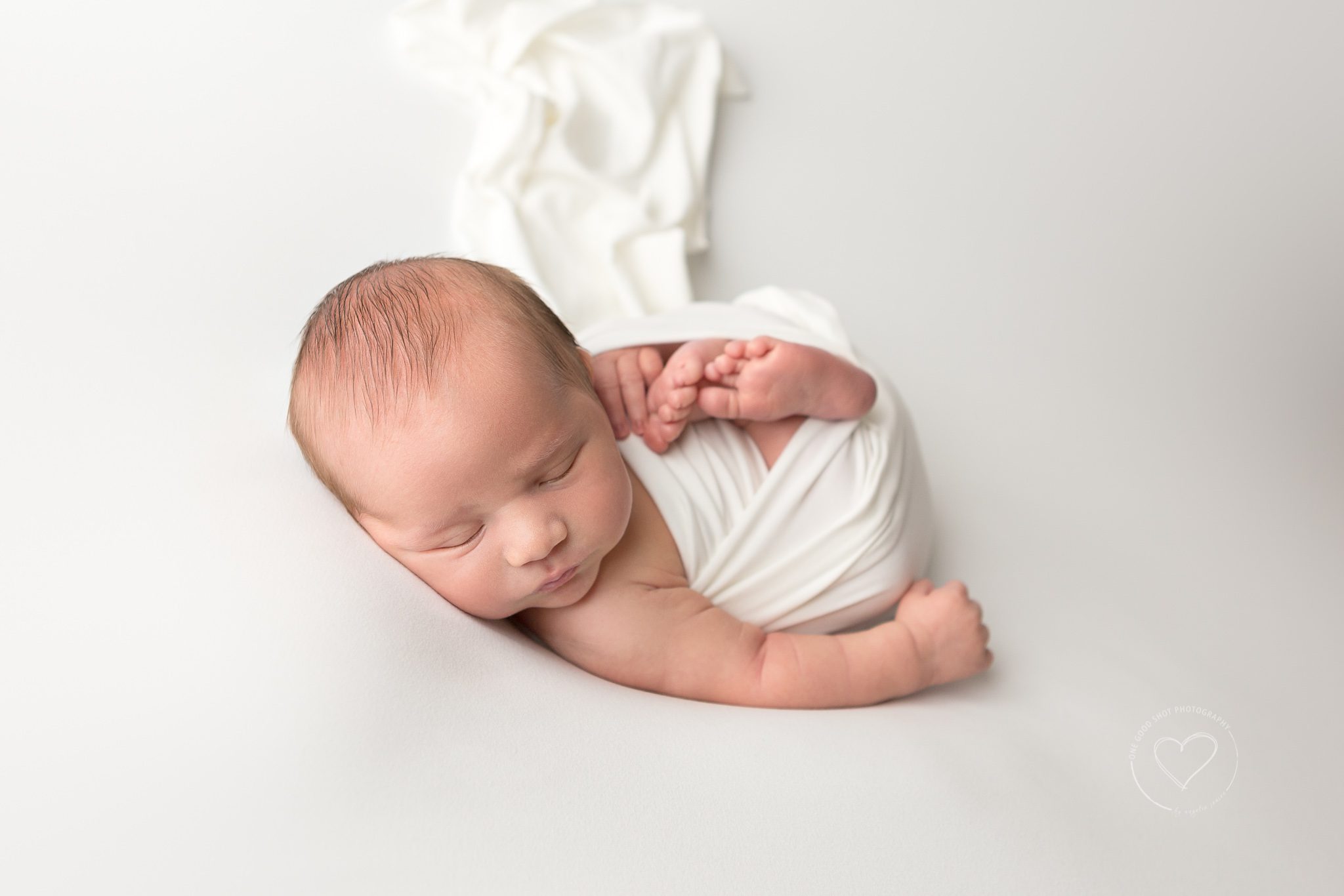Newborn boy, wrapped in white, white background, huck Finn pose, Fresno Clovis, photographer
