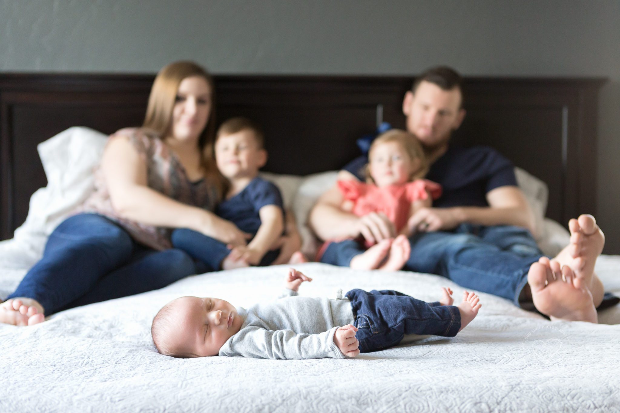 Newborn Lifestyle Photography, Family sitting on bed gazing at new baby, Fresno, Clovis, CA