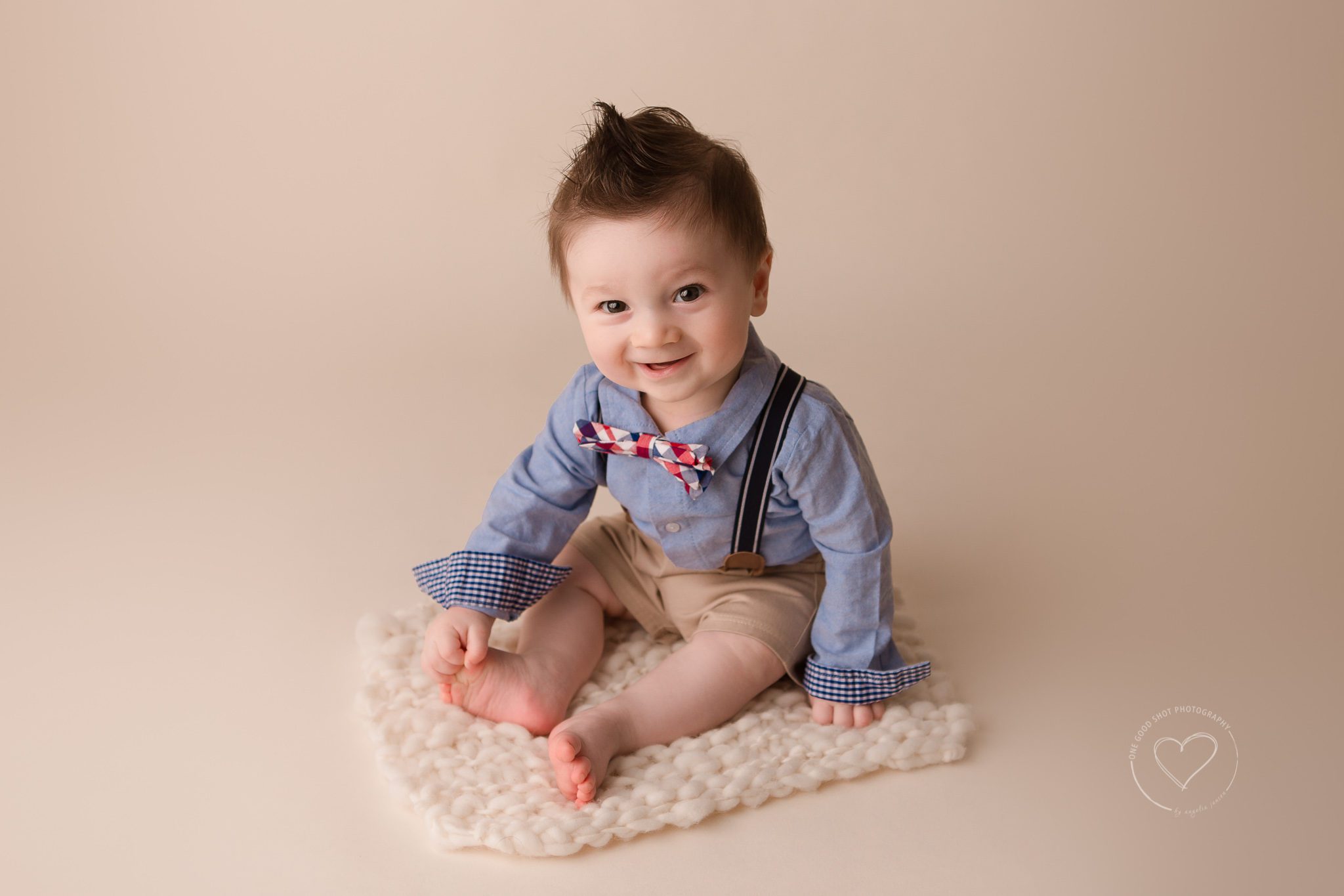 Fresno Baby Photographer, 6 month, boy, sitting, suspenders and bow tie, smiling
