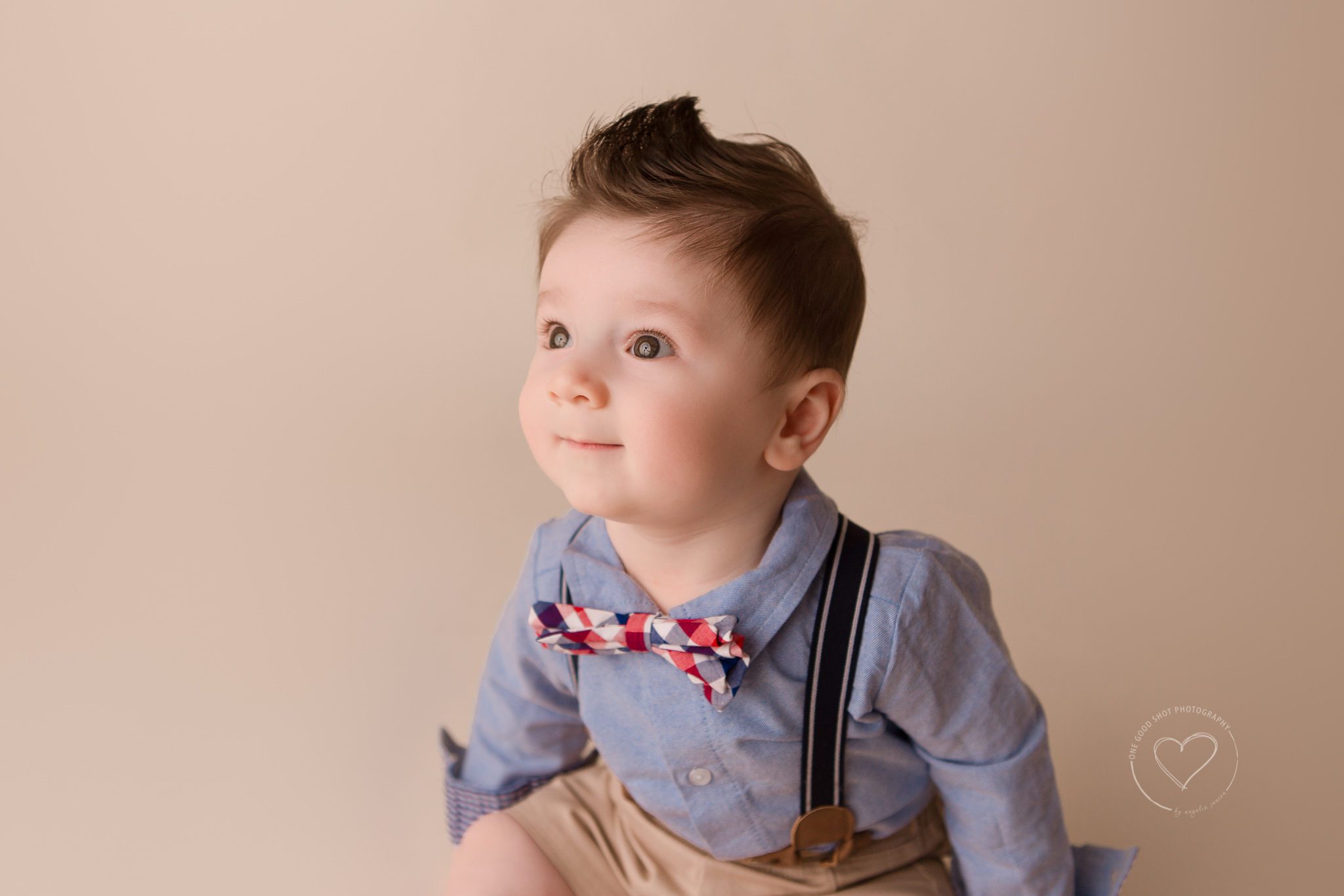 Fresno Baby Photographer, 6 month, boy, sitting, suspenders and bow tie, smiling