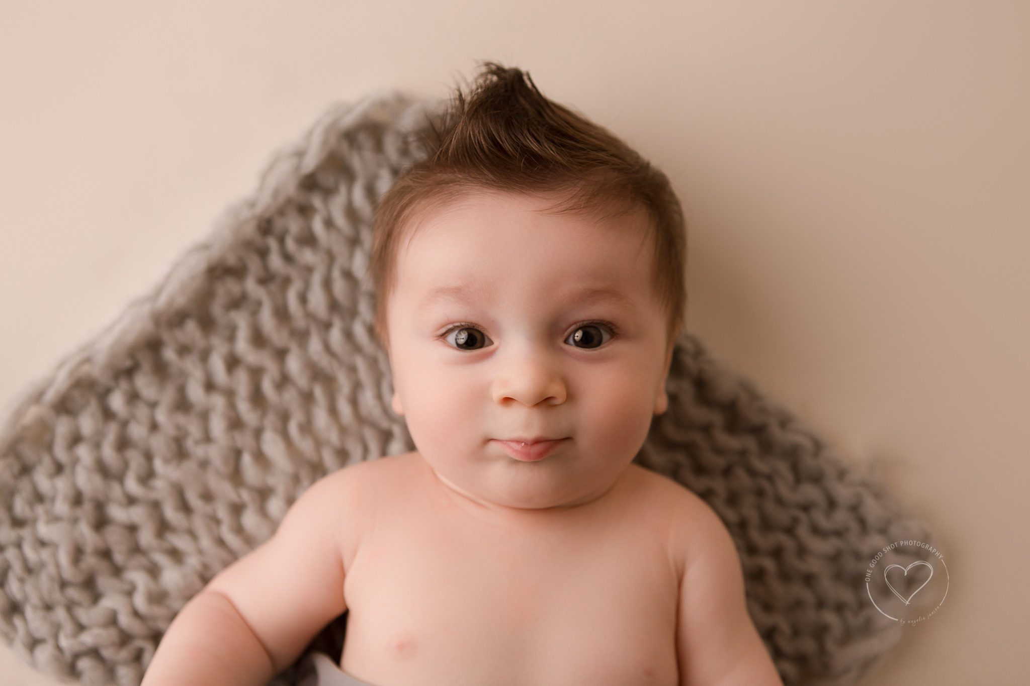 Fresno Baby Photographer, 6 month old boy, laying down looking up at camera