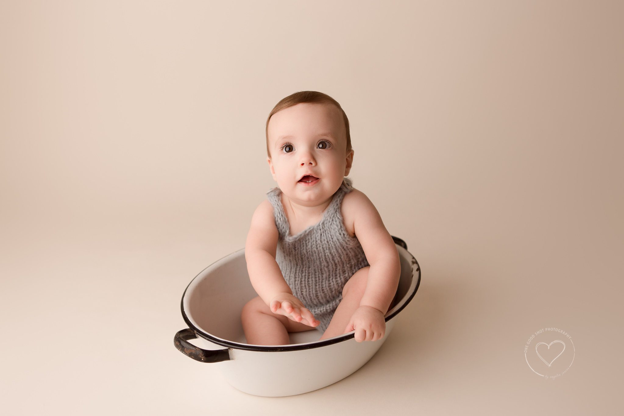 Baby photographer, Fresno, clovis, 9 months, gray knit romper, sitting in vintage wash bin