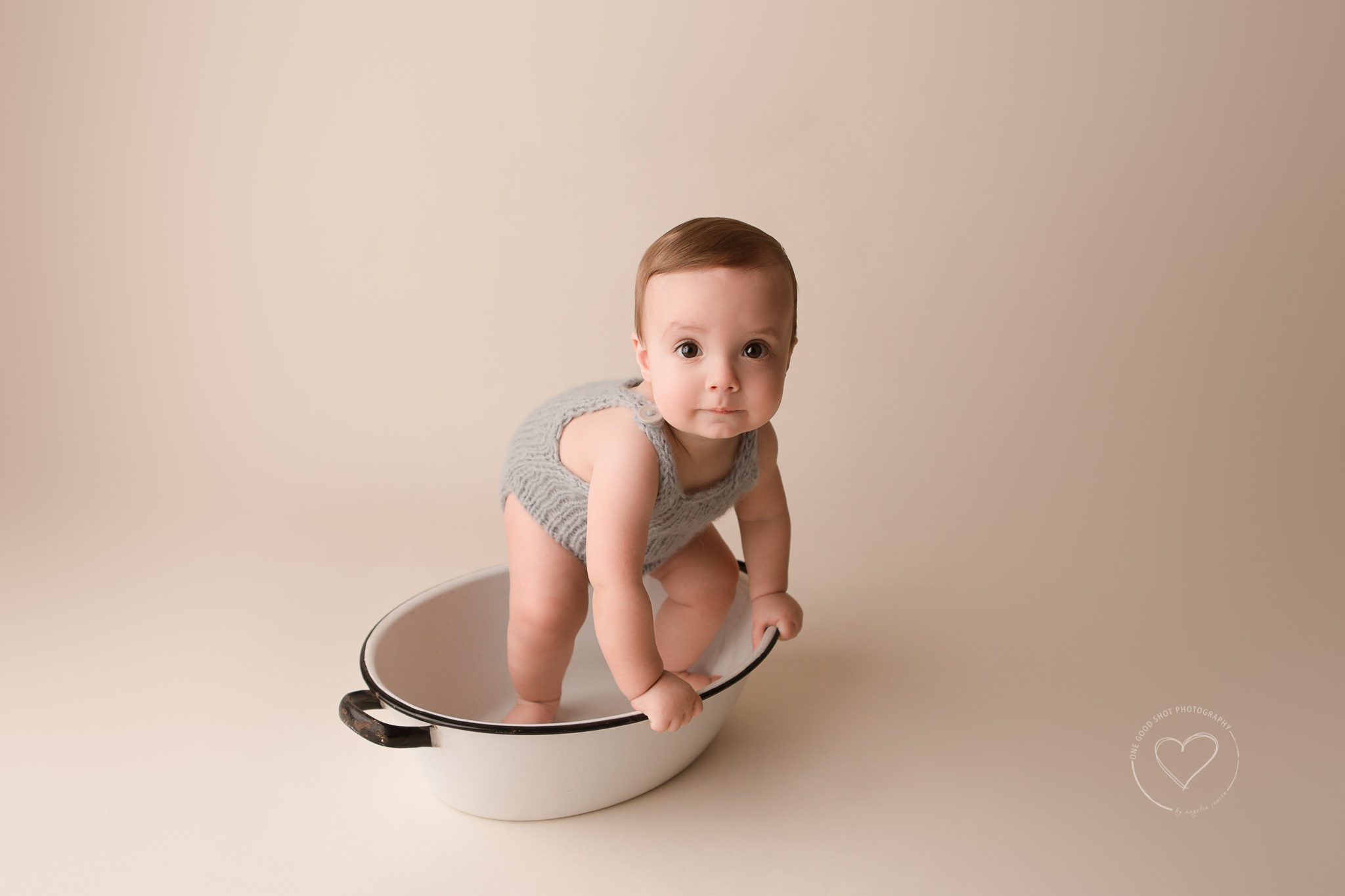 baby photographer, Fresno, clovis, 9 months, boy, gray knit romper, standing in vintage wash bin