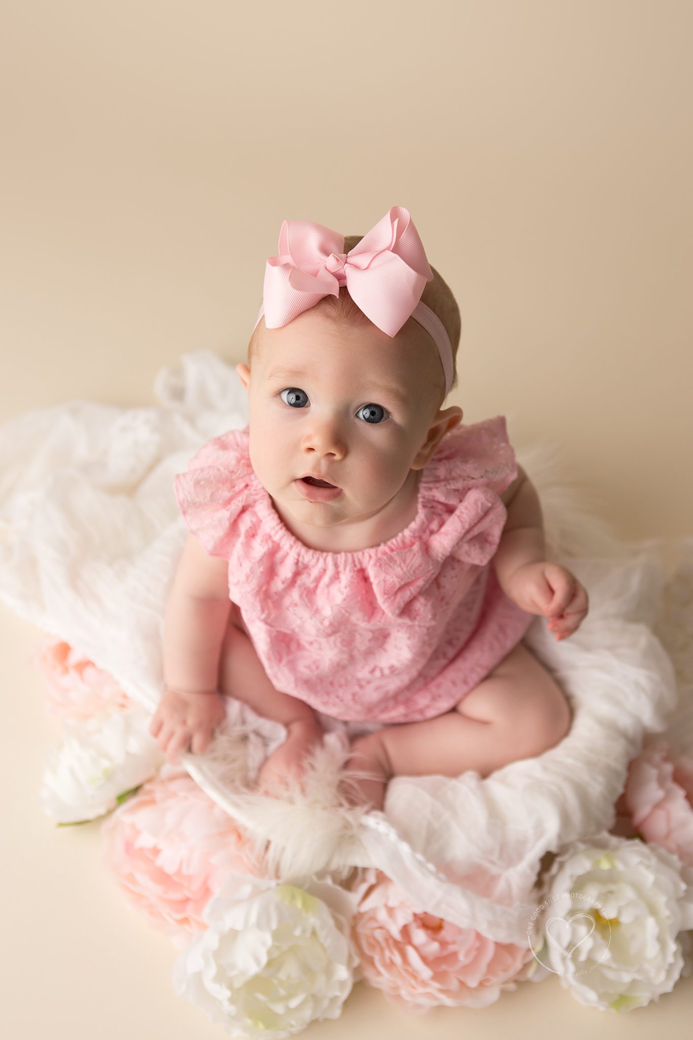fresno, clovis, photographer, baby, girl, pink romper, pink bow, white fur, 6 months, sitter