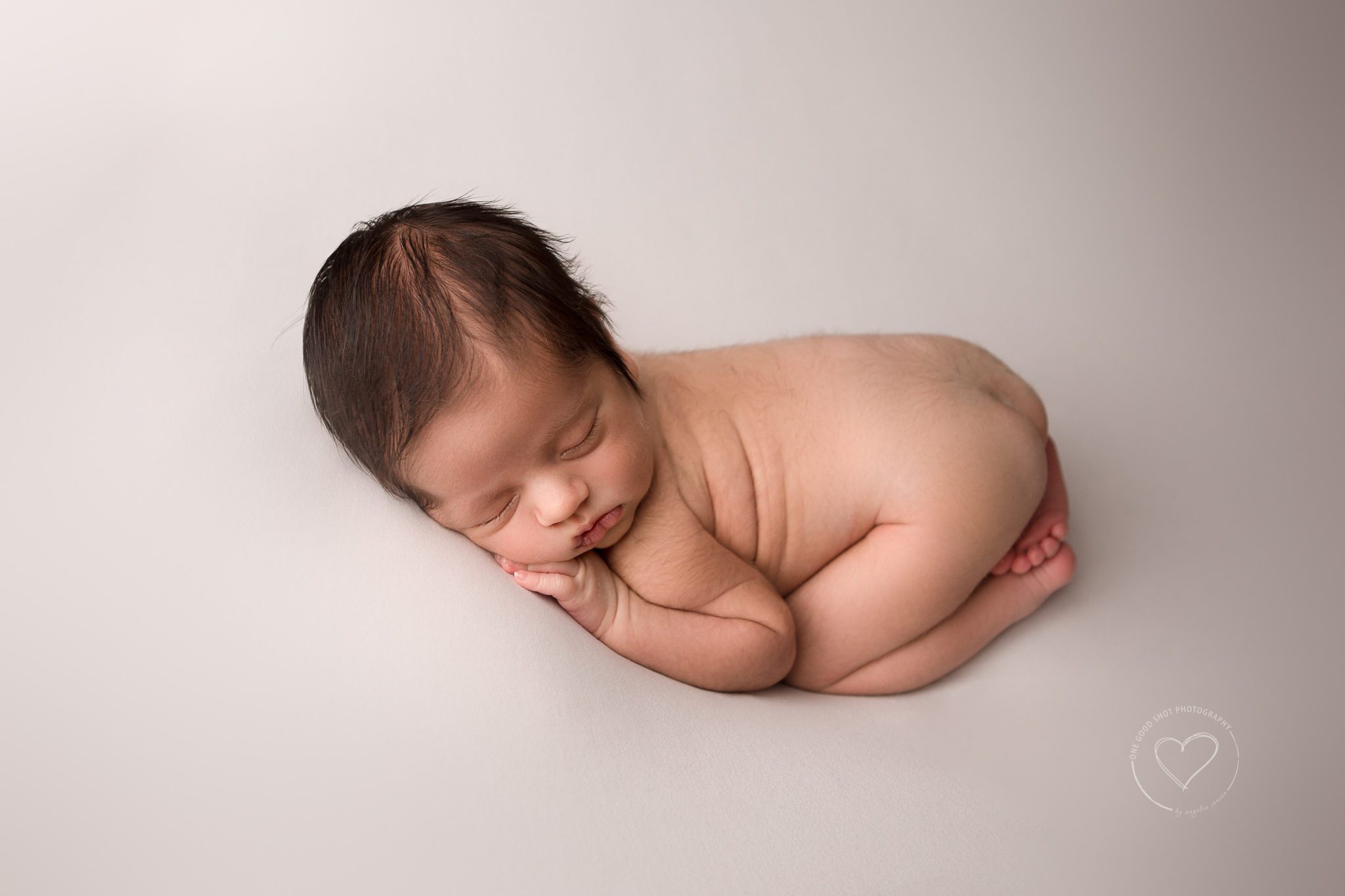 Newborn Photography Fresno, baby boy in tushy up position on white backdrop sleeping, one good shot