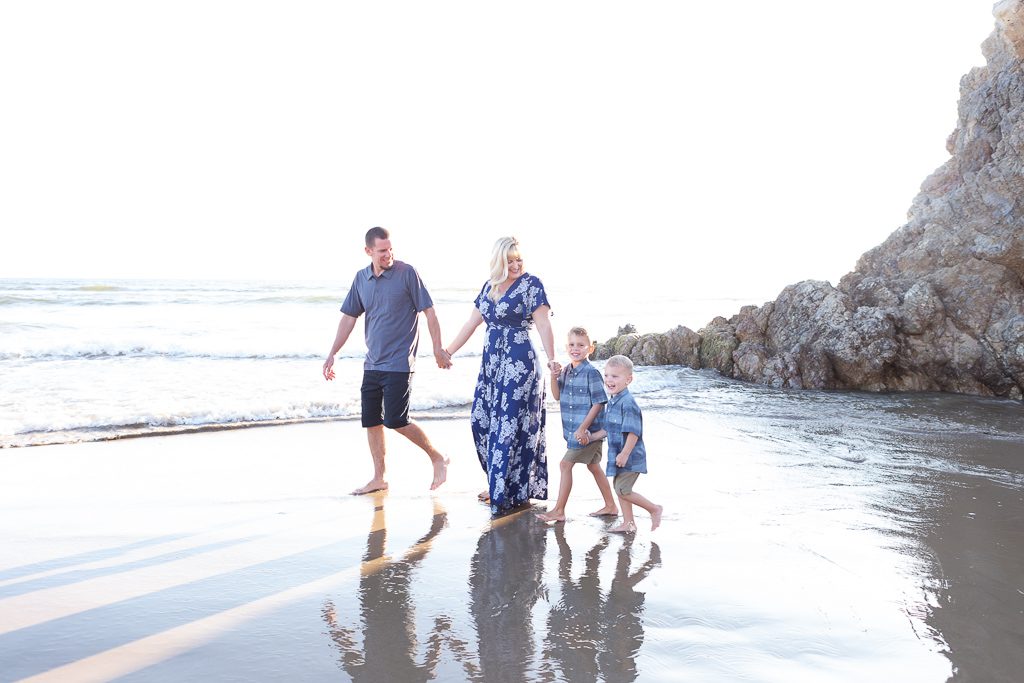Family beach pictures, family walking hand in hand, barefoot, blue and navy colors