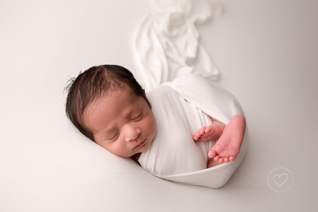 Fresno Newborn Photographer, modified huck Finn pose, white wrap, white backdrop