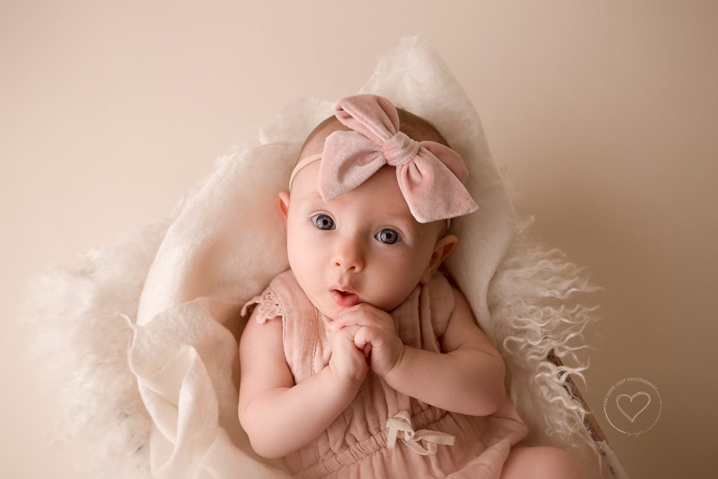 3 month old baby girl milestone photos, pink romper, pink bow, holding hands together, fresno, baby, photographer