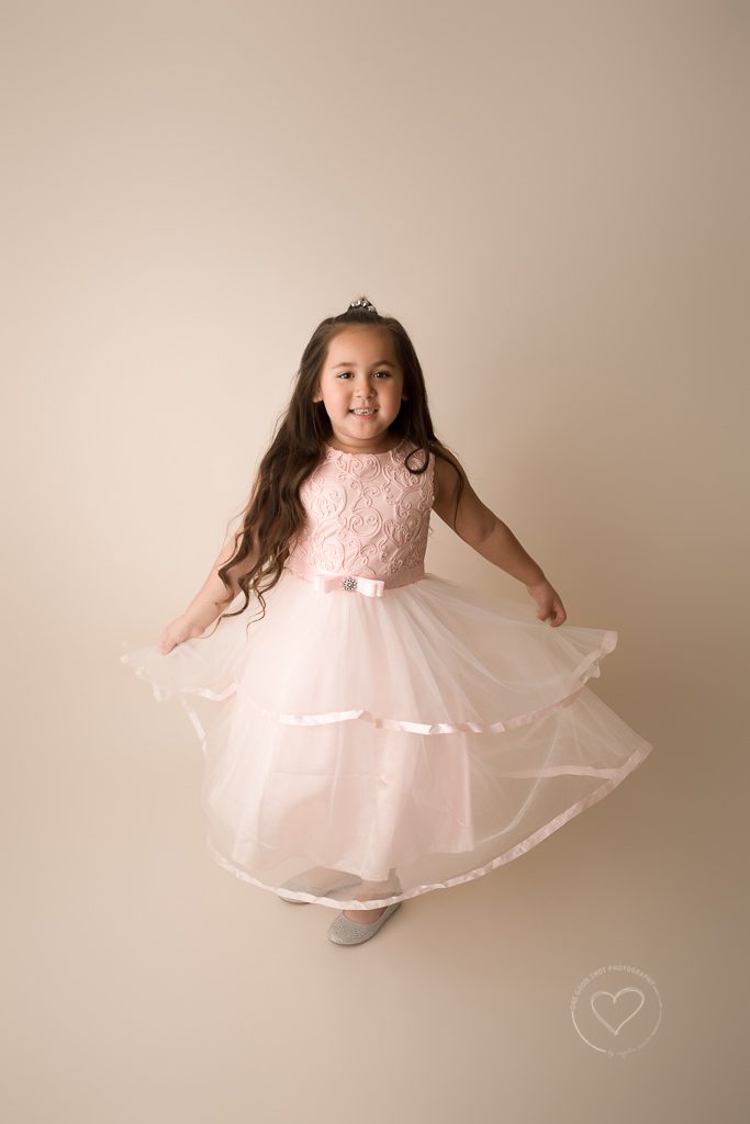little girl twirling in pink dress, studio photography, fresno, Clovis