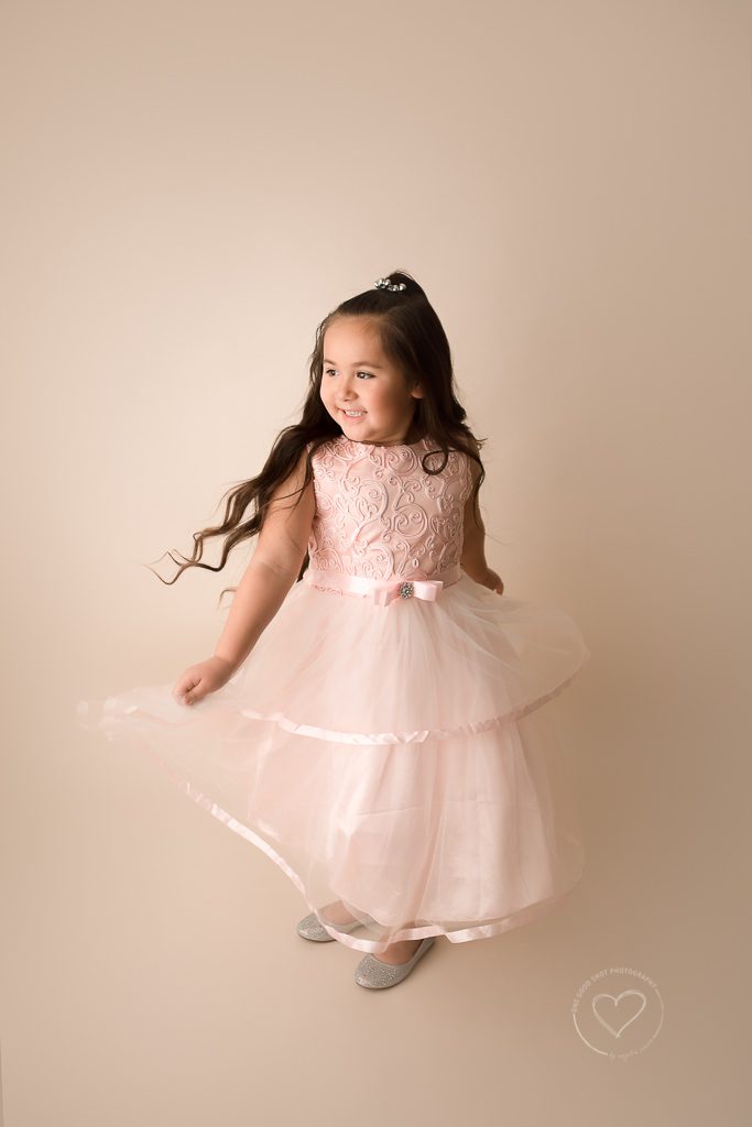 little girl twirling in pink dress, studio photographer, fresno