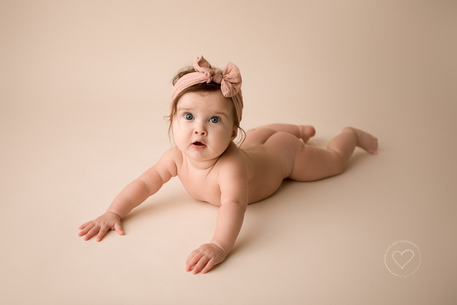 6 month milestone photos, studio photography, baby girl, tummy pose, pink bow