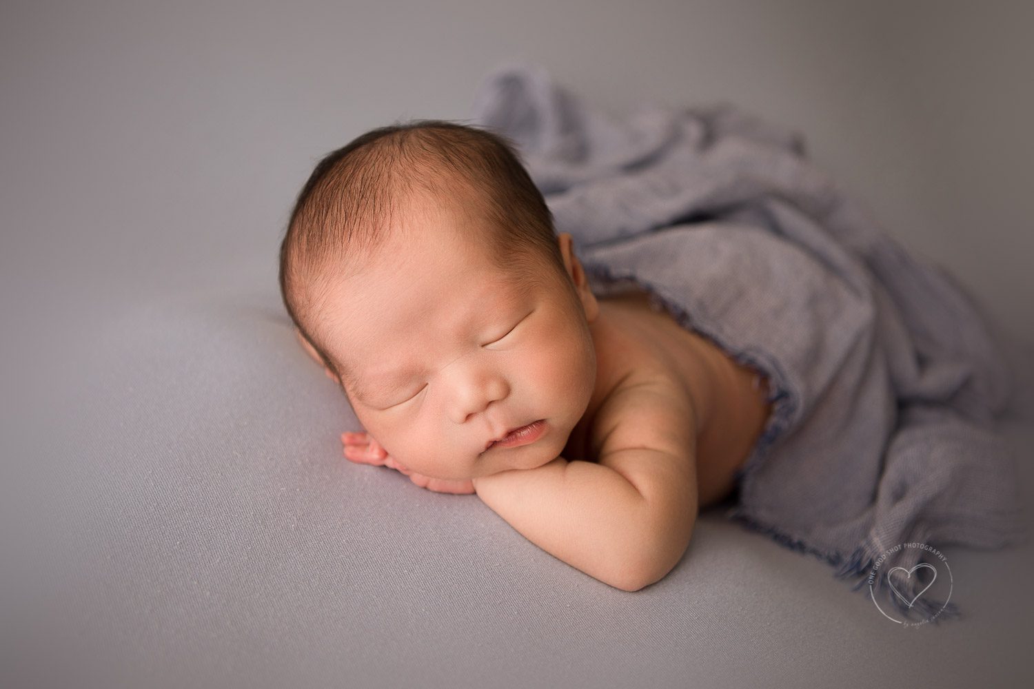 Newborn photos, baby boy, head on hands, gray backdrop, gray layer, fresno, Clovis 