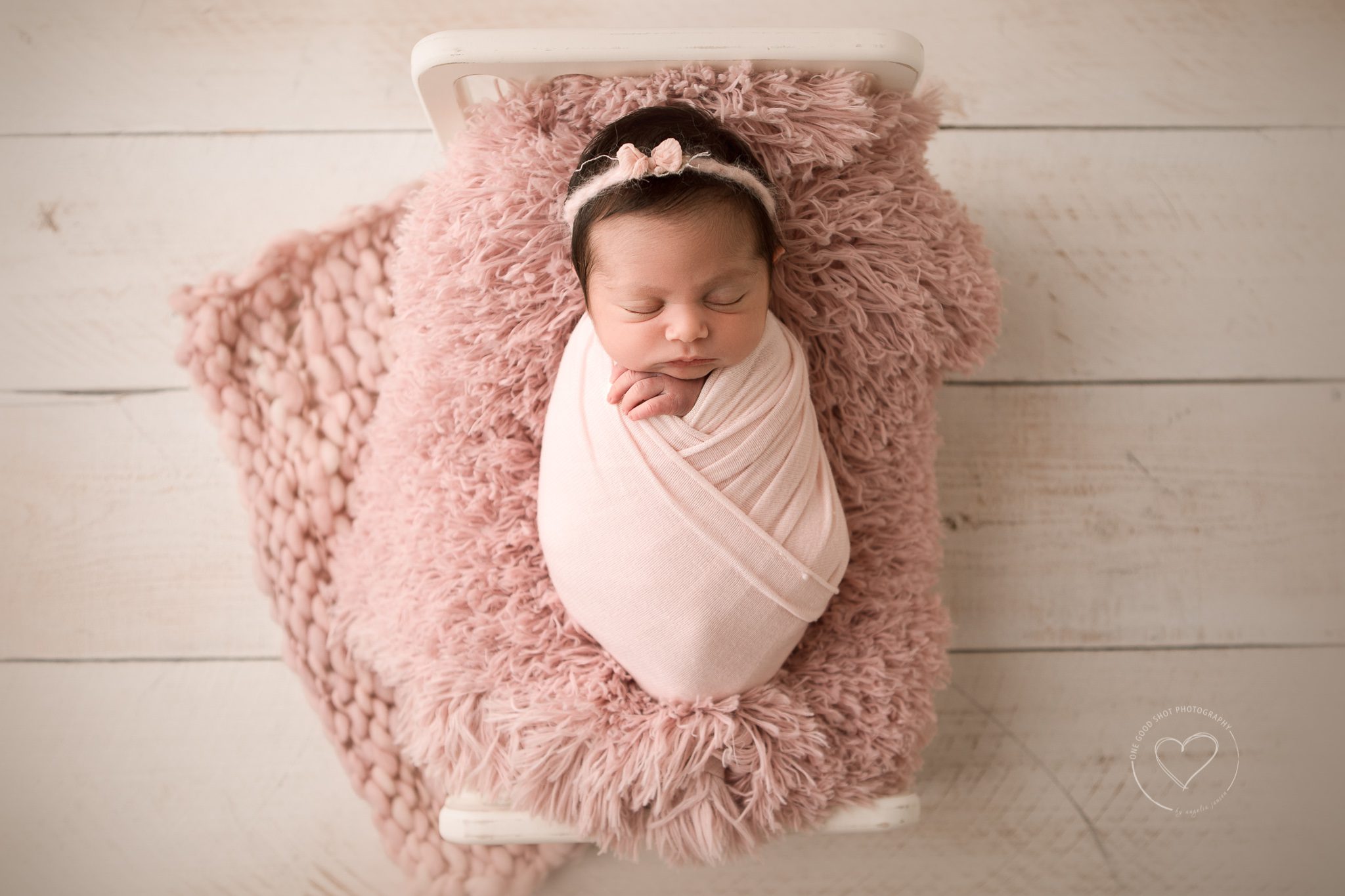 Newborn girl Photos, Baby wrapped in pink, laying on pink layer, pink bow, fresno, clovis, photographer, one good shot photography