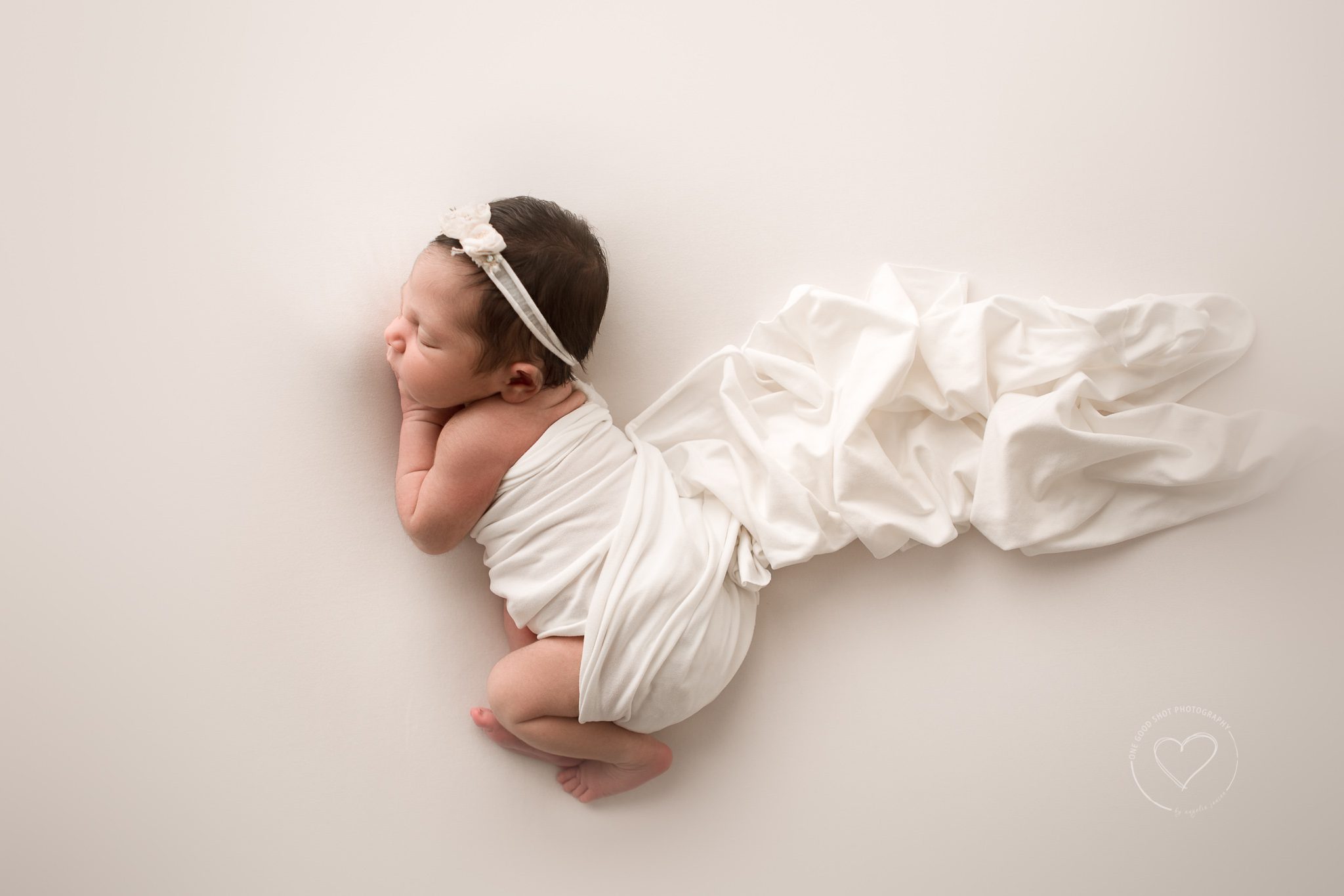 newborn girl photo, side lying pose shot from above, neutral, white, fresno, clovis, photographer 