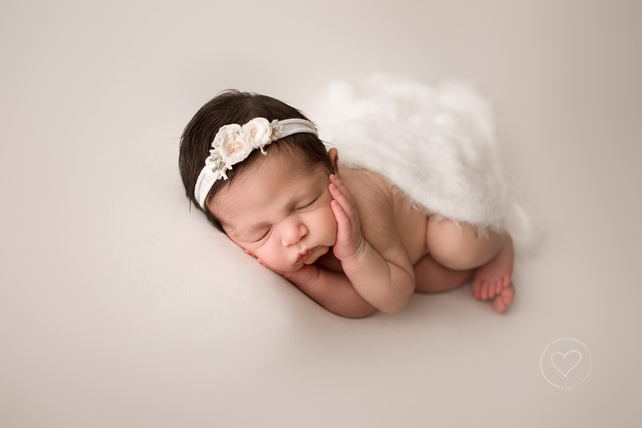 newborn girl photo, side lying pose, hands cupping face, neutrals, whites, fresno, clovis, photographer